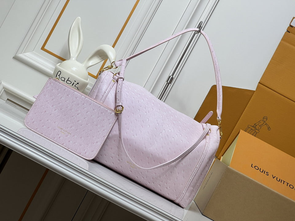 Louis Vuitton Keepall Bandoulière in blush pink ostrich-embossed leather with matching mini pouch and gold-tone hardware