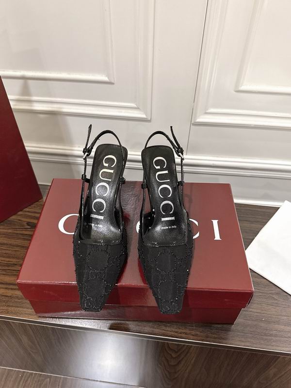 Gucci GG canvas slingback pointed-toe heels in tonal black, shown from above on red Gucci box